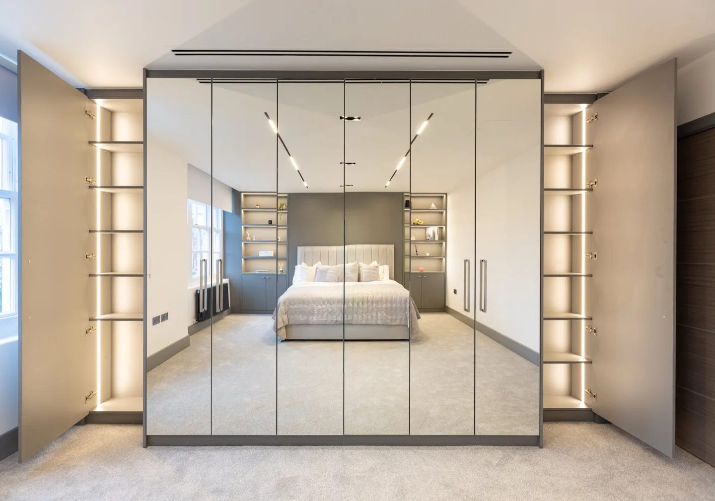 Bespoke fitted wardrobe full wall mirrored display shelves — Kensington