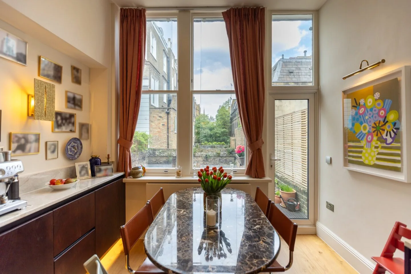 Kitchen dining area with sash windows and handle-less hardwood cabinetry — Phillimore Gardens, Kensington