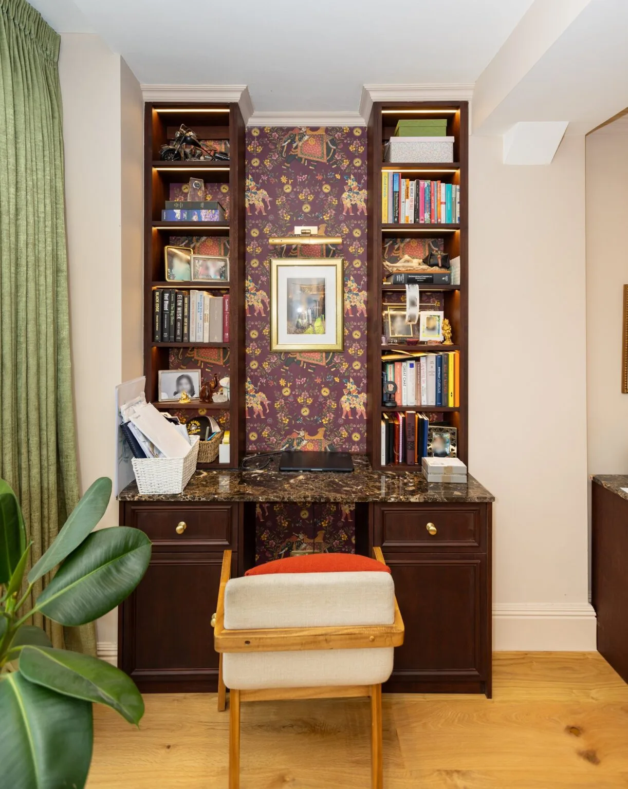 Oak built-in desk with integrated bookshelves and wallpapered panel — Phillimore Gardens, Kensington