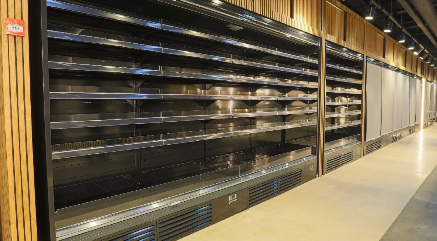 Run of bespoke shelving bays framed by slatted oak panelling