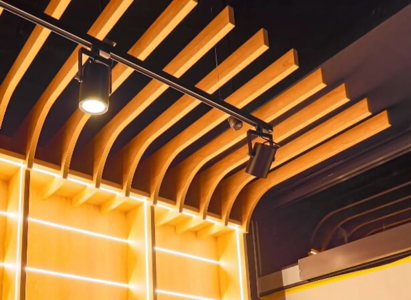 Detail of curved oak ribs and concealed LED lighting on the ceiling