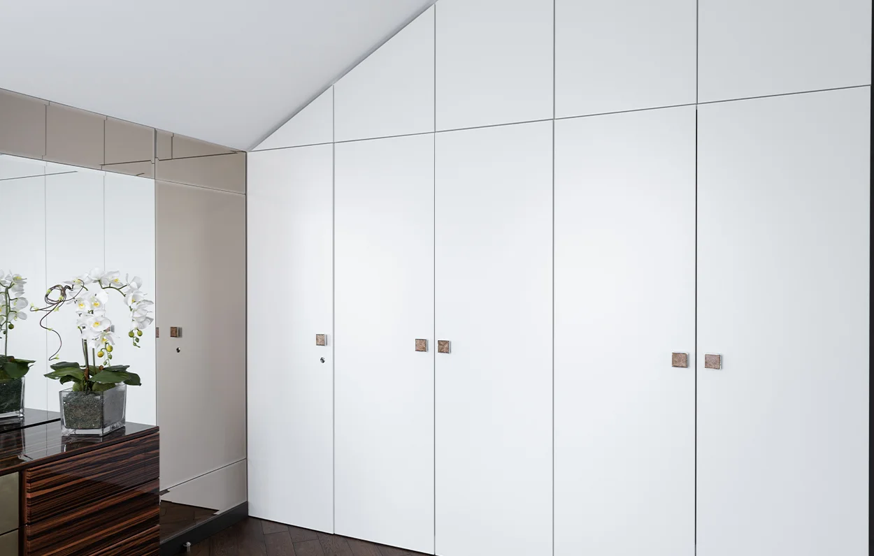 White built-in wardrobe maximising an awkward corner space