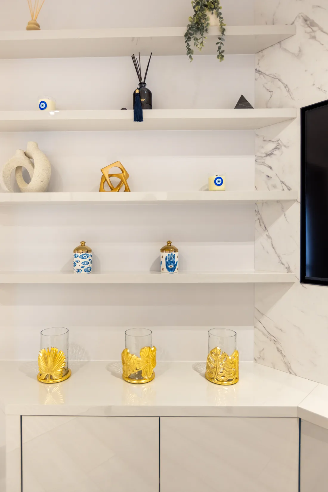 Bespoke media wall detail with a marble surround and floating shelves