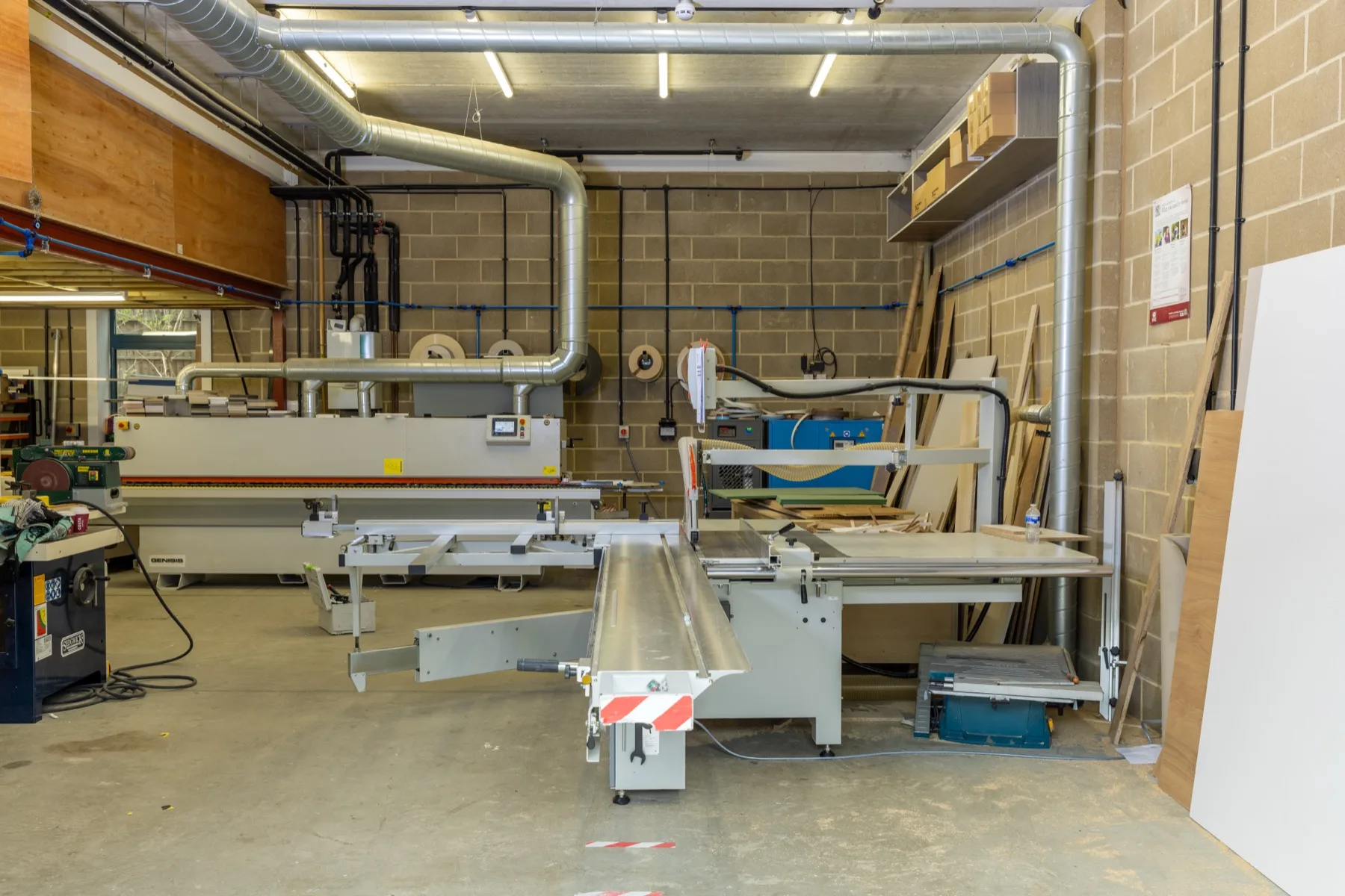 Wide view of the Yasmeen Joinery workshop — edge bander, panel saw and dust extraction